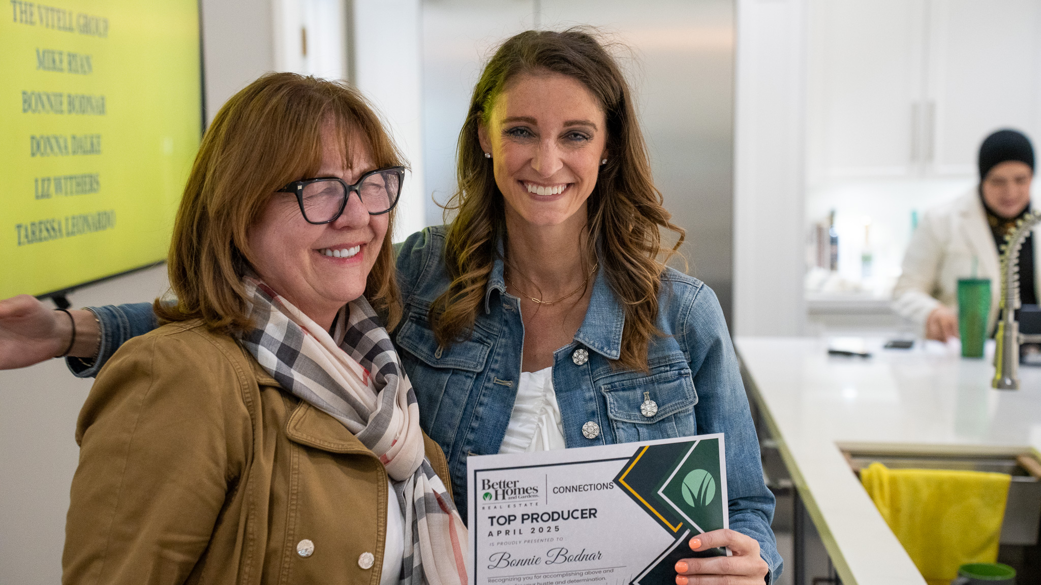 Broker manager presenting award to top producing real estate agent at Better Homes and Gardens Real Estate Connections in Oak Forest